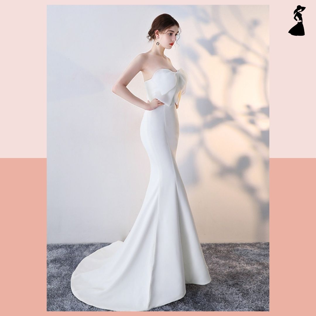 ชุดราตรี ชุดออกงาน ชุดไปงานแต่งงานสีขาว เดรสยาวเกาะอกแต่งโบว์ กระโปรงยาวทรงหางปลา แนวเรียบหรู สวยสง่า ดูแพง