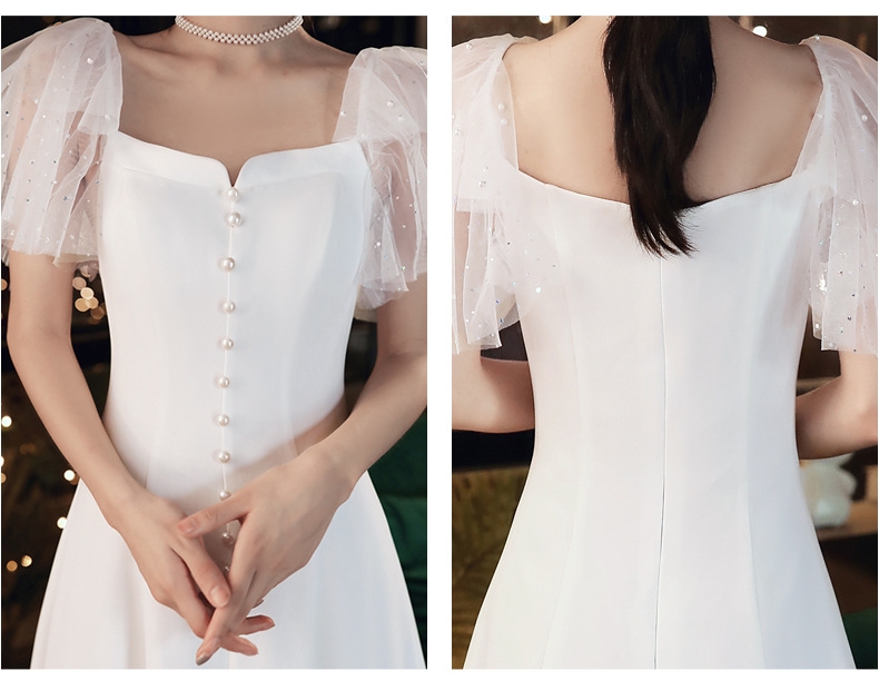 ชุดเดรสออกงานสีขาว แขนระบายผ้ามุ้ง แต่งกระดุมมุก กระโปรงสั้นทรงบาน เรียบหรู สวยดูดี สไตล์มินิมอล ใส่เป็น ชุดราตรี ชุดออกงาน ชุดไปงานแต่งงาน กลางวัน กลางคืน