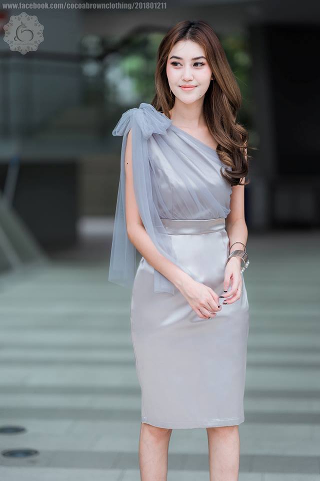 ชุดออกงานราตรีสั้นสีเทา ทรงเข้ารูป ไหล่เฉียงข้าง แต่งด้วยผ้าซีทรูยาวระบายหลังผูกเป็นโบว์ได้หลายแบบ