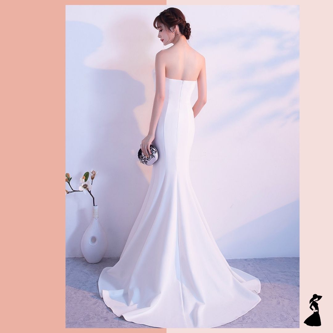 ชุดราตรี ชุดออกงาน ชุดไปงานแต่งงานสีขาว เดรสยาวเกาะอกแต่งโบว์ กระโปรงยาวทรงหางปลา แนวเรียบหรู สวยสง่า ดูแพง