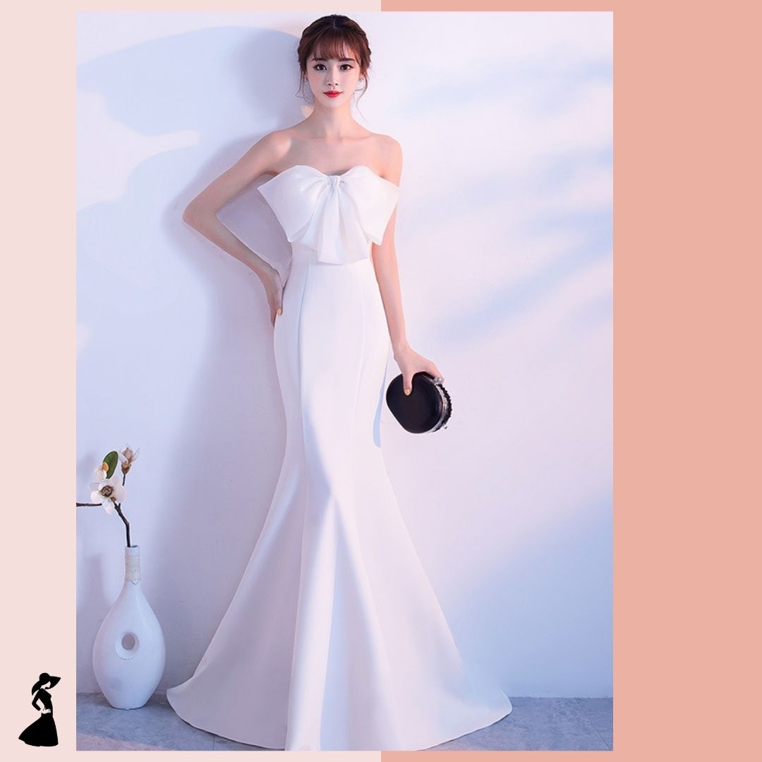 ชุดราตรี ชุดออกงาน ชุดไปงานแต่งงานสีขาว เดรสยาวเกาะอกแต่งโบว์ กระโปรงยาวทรงหางปลา แนวเรียบหรู สวยสง่า ดูแพง